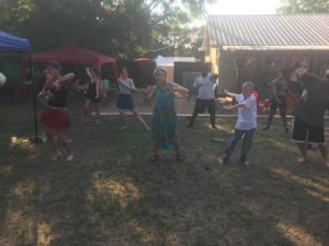 Photo of group warming up for Yoga in the SHINE courtyard